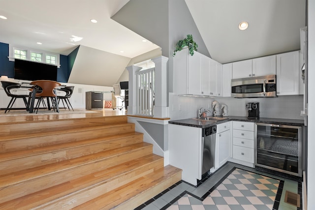 615 E 16th Ave, Spokane, WA 99203 - kitchen with a sink, stainless steel appliances, wine cooler, recessed lighting, and vaulted ceiling