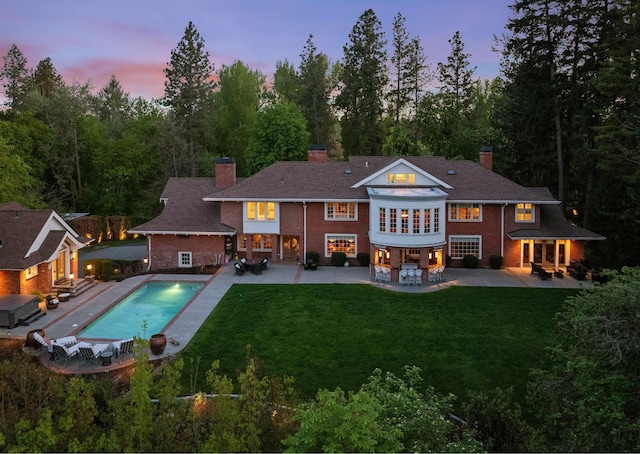 615 E 16th Ave, Spokane, WA 99203 - back of property with a yard, a patio, and a chimney