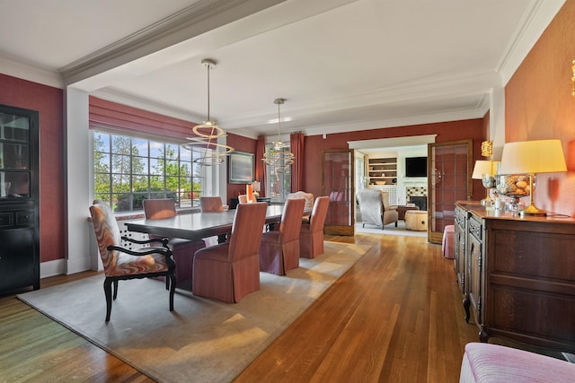 615 E 16th Ave, Spokane, WA 99203 - dining space featuring crown molding, wood finished floors, and an inviting chandelier