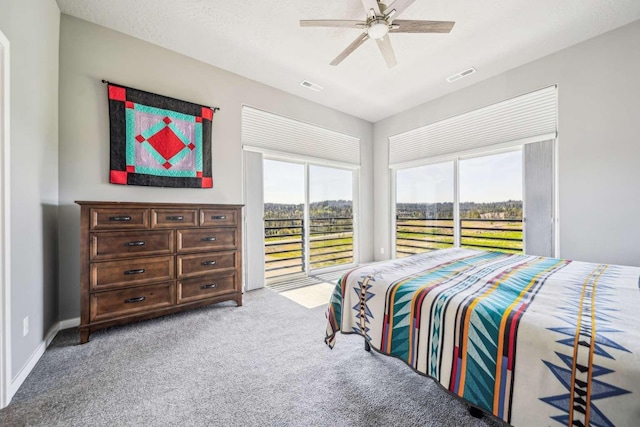 carpeted bedroom with visible vents, a ceiling fan, and access to exterior
