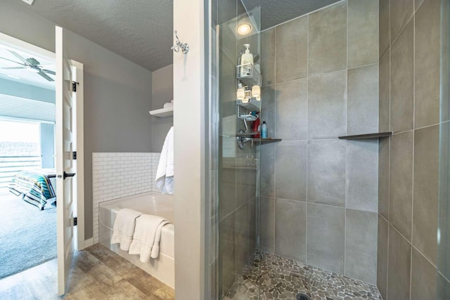 ensuite bathroom featuring connected bathroom, a tile shower, a ceiling fan, wood finished floors, and a bath