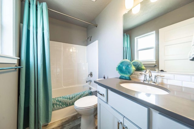 full bathroom with a textured ceiling, shower / bath combination with curtain, wood finished floors, vanity, and toilet