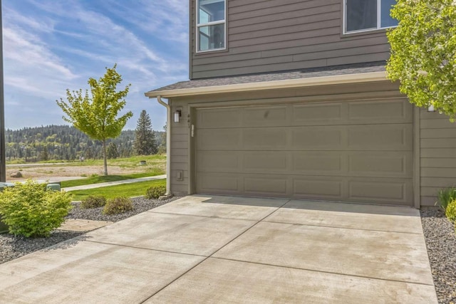 garage with concrete driveway