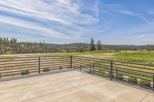 view of patio / terrace featuring a forest view