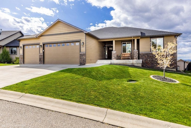 6025 N Hillmont Ln, Spokane, WA 99217 - view of front of property featuring an attached garage, a front lawn, stone siding, a porch, and concrete driveway