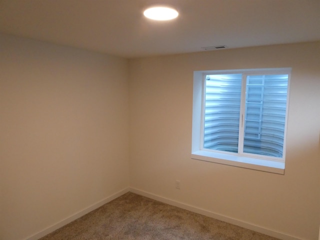 carpeted spare room with baseboards and visible vents