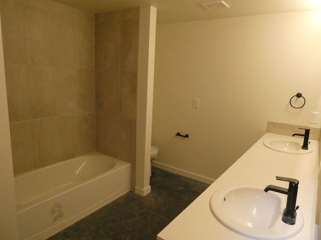 bathroom with double vanity, toilet, visible vents, and a sink