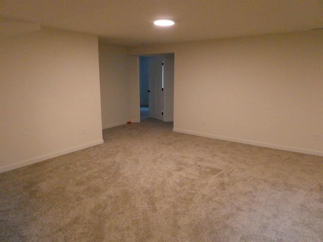 spare room featuring carpet floors, recessed lighting, and baseboards