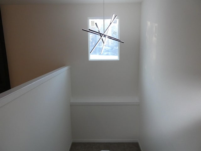 details with baseboards and a chandelier