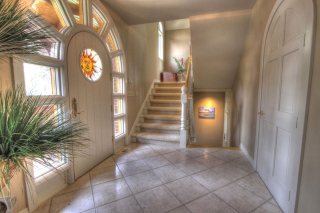 2010 E Pinecrest Rd, Spokane, WA 99203 - foyer entrance with light tile patterned floors, baseboards, stairway, and a healthy amount of sunlight