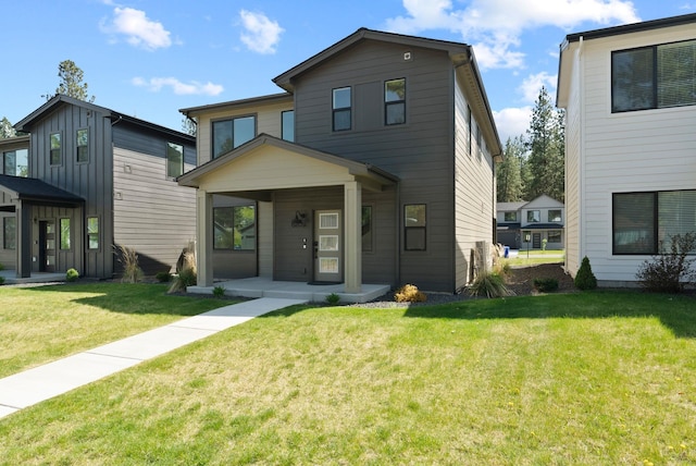 contemporary house with a porch and a front lawn