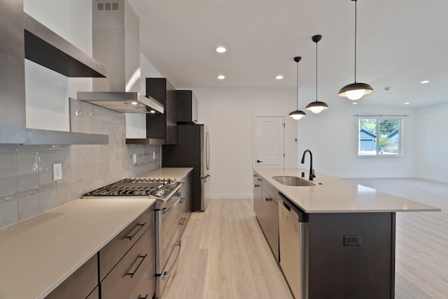 kitchen featuring gas range, a sink, light countertops, dishwashing machine, and light wood-style floors