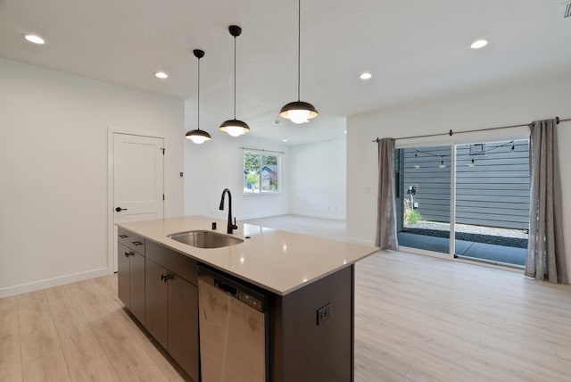 kitchen with a sink, light wood-style floors, stainless steel dishwasher, and recessed lighting