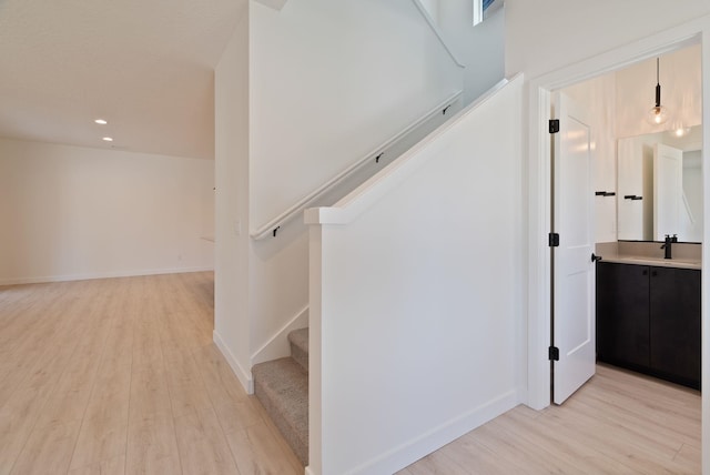 stairs featuring recessed lighting, baseboards, and wood finished floors