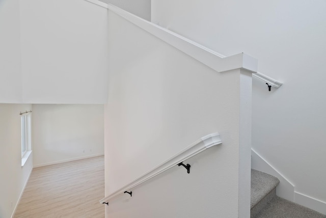 stairway with wood finished floors