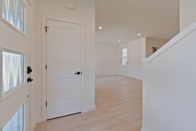 foyer featuring recessed lighting, baseboards, and light wood finished floors