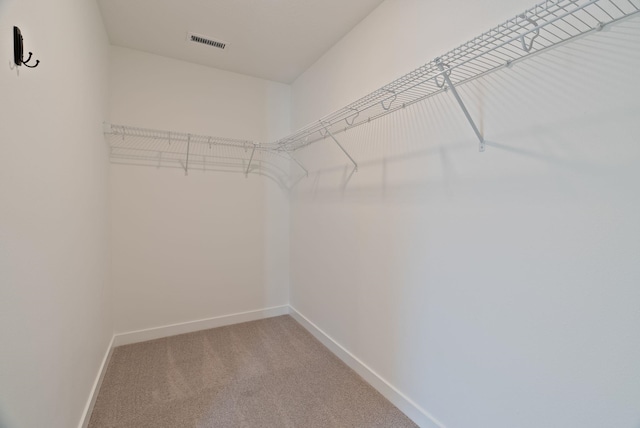 spacious closet with light carpet and visible vents