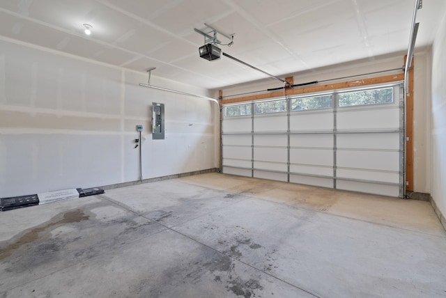 garage with a garage door opener and electric panel