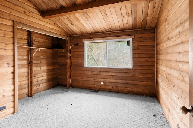 unfurnished bedroom featuring carpet floors, wooden walls, lofted ceiling with beams, and wood ceiling