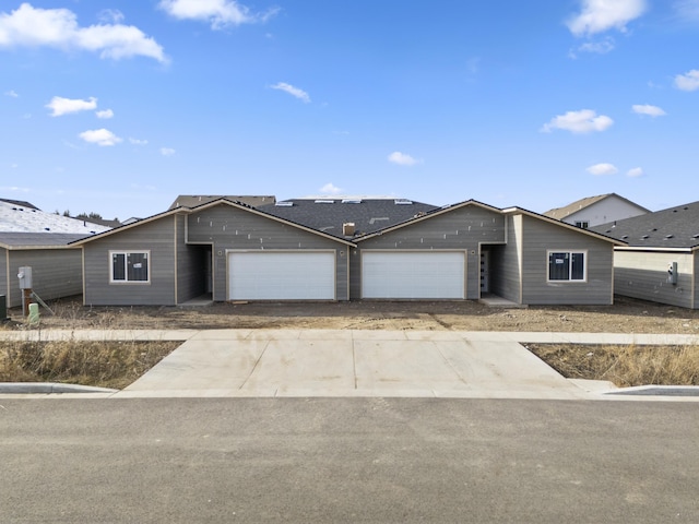 ranch-style home with driveway and a garage