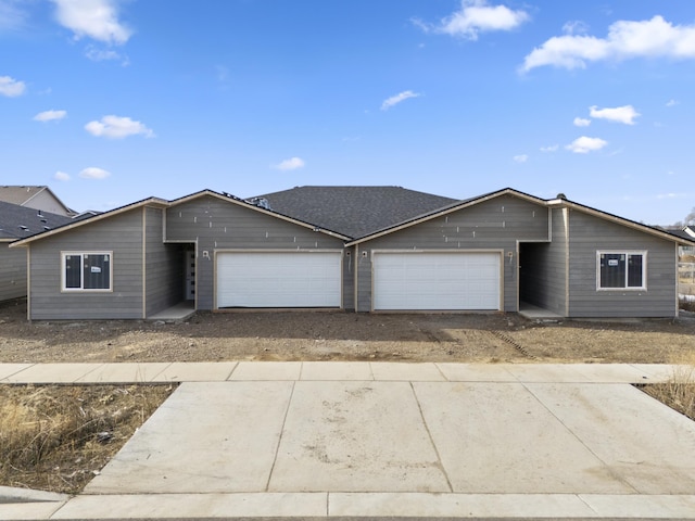 ranch-style house with an attached garage and concrete driveway