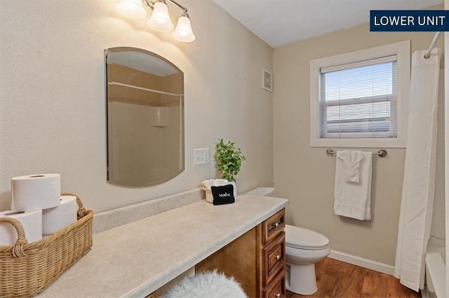bedroom featuring baseboards, wood finished floors, and visible vents