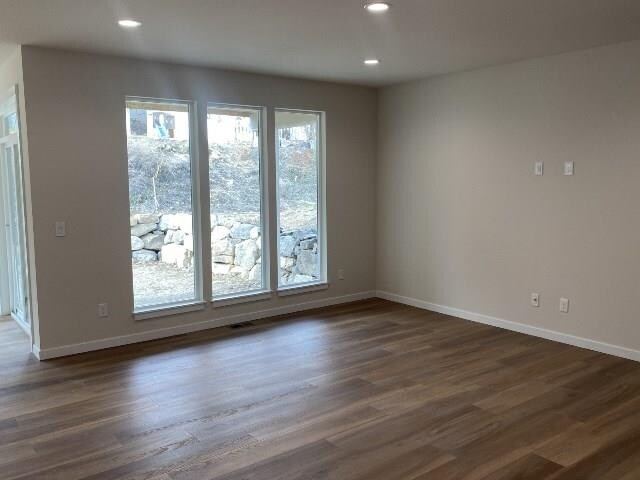 4408 S Willow Ln, Spokane Valley, WA 99216 - empty room featuring plenty of natural light, recessed lighting, baseboards, and dark wood finished floors