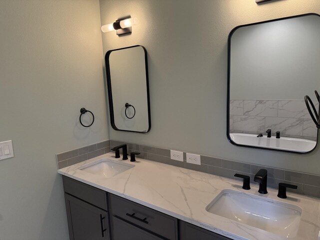 4408 S Willow Ln, Spokane Valley, WA 99216 - bathroom featuring double vanity, a sink, and tasteful backsplash