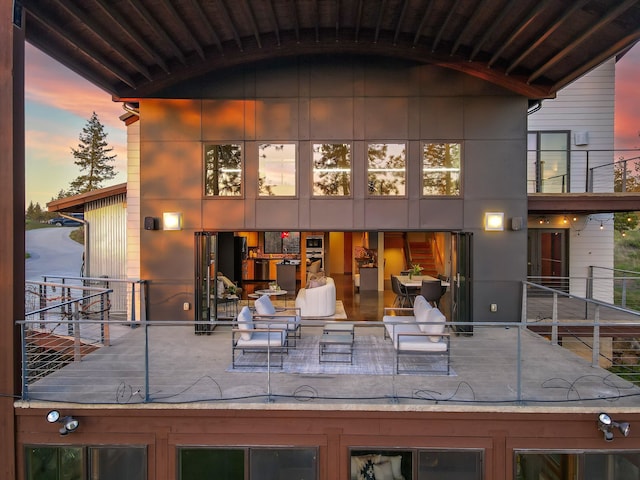 rear view of property with a balcony