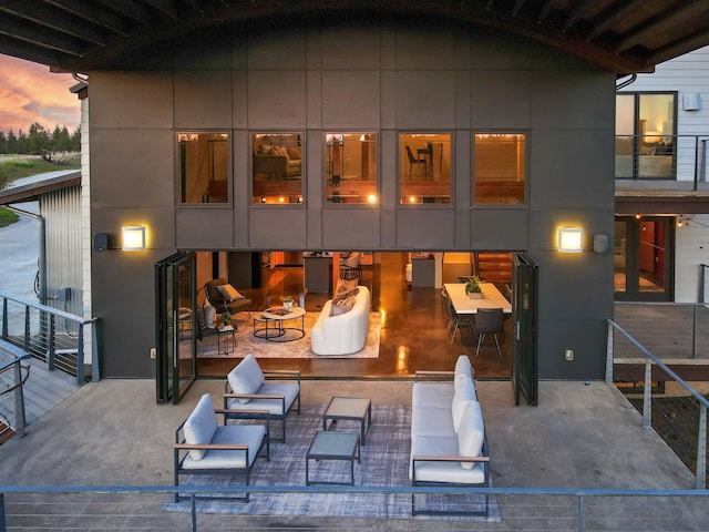rear view of house featuring a patio and an outdoor hangout area