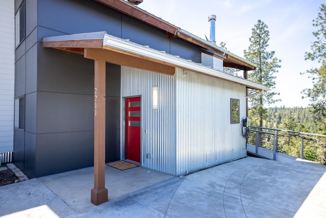 view of exterior entry featuring a patio