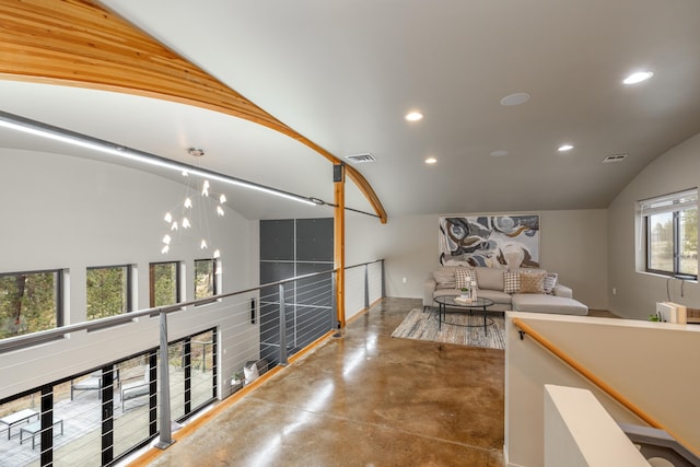 hall with vaulted ceiling, recessed lighting, finished concrete floors, and visible vents