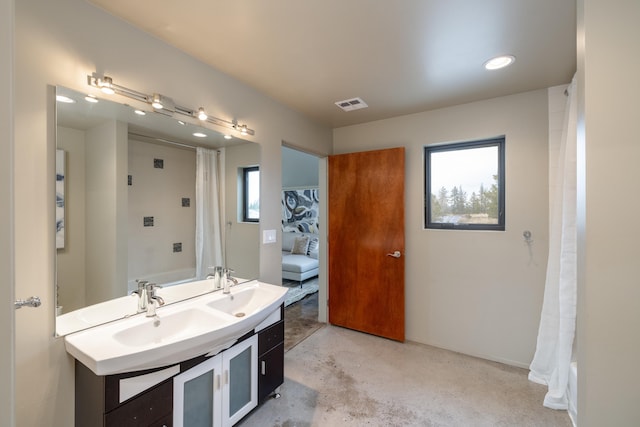 full bath with a sink, double vanity, concrete floors, curtained shower, and visible vents