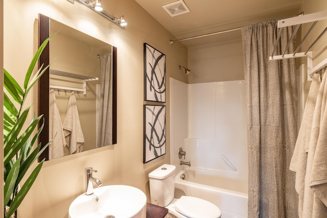 full bathroom featuring toilet, visible vents, shower / bathtub combination with curtain, and a sink
