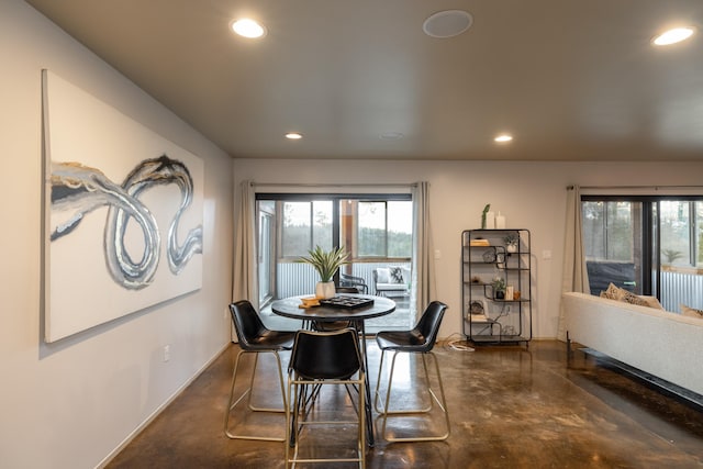 dining room featuring recessed lighting, concrete flooring, and a healthy amount of sunlight