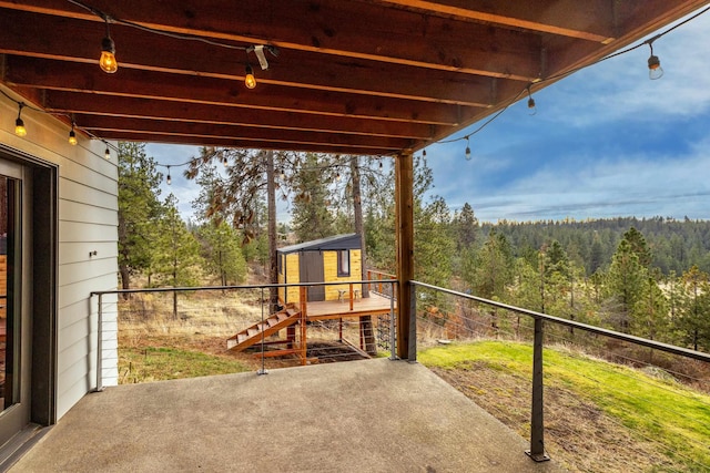 view of patio featuring a forest view