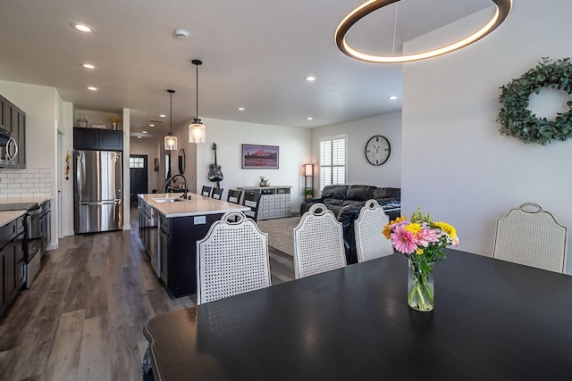 dining area featuring dark wood-style flooring and recessed lighting