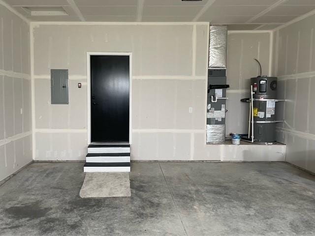 garage with water heater and electric panel