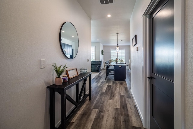 corridor with recessed lighting, baseboards, visible vents, and dark wood-type flooring