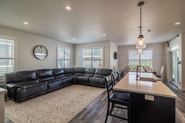 living area featuring plenty of natural light, recessed lighting, and dark wood finished floors