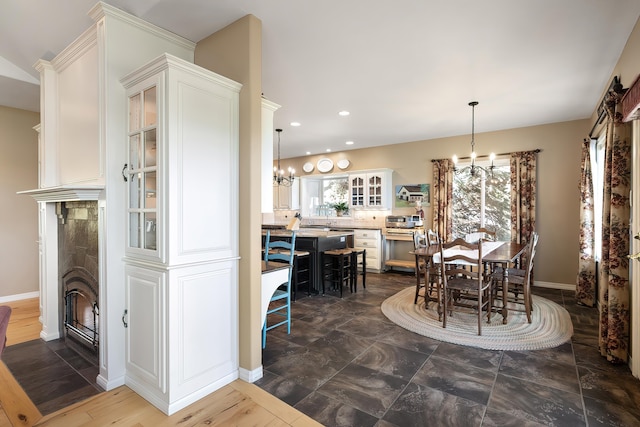dining area with recessed lighting, baseboards, a chandelier, and a healthy amount of sunlight