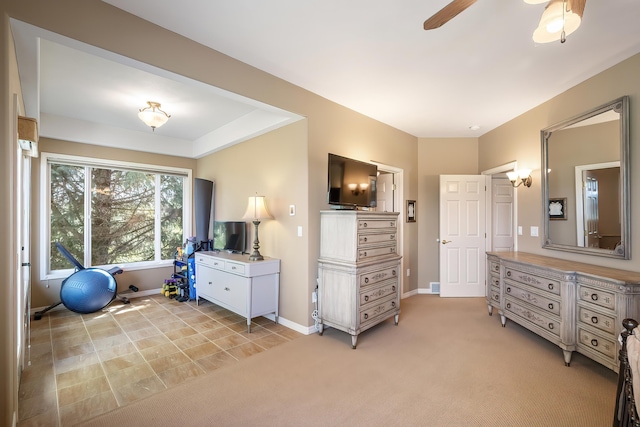 bedroom with a ceiling fan, baseboards, and light colored carpet