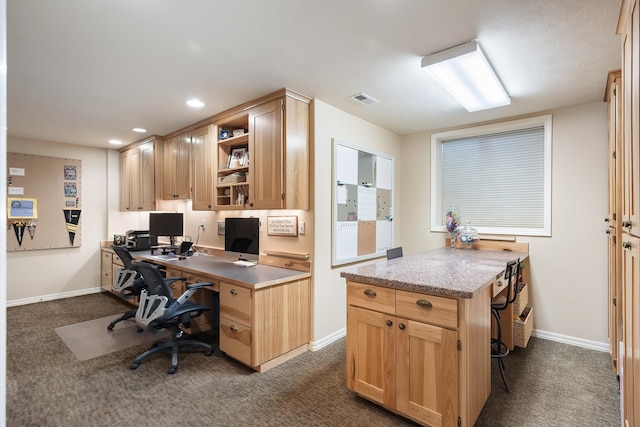 office featuring visible vents, baseboards, and dark carpet
