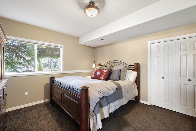bedroom featuring baseboards, dark colored carpet, and visible vents