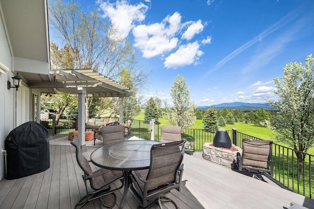 deck with a pergola, a mountain view, outdoor dining area, and a grill