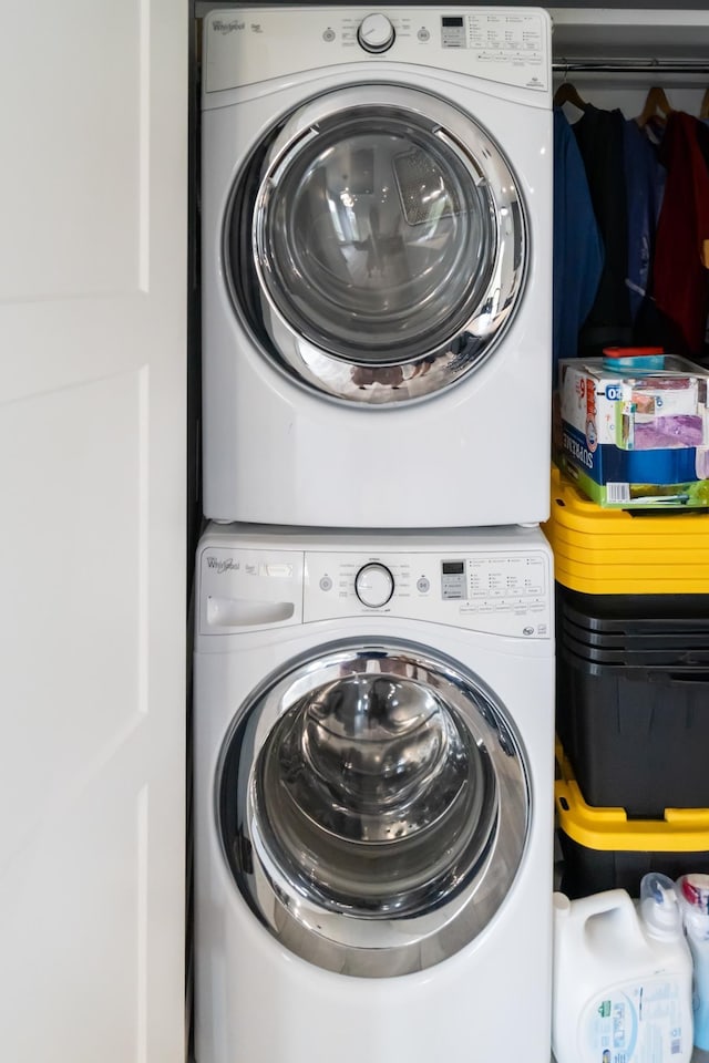 laundry room with stacked washer and clothes dryer and laundry area