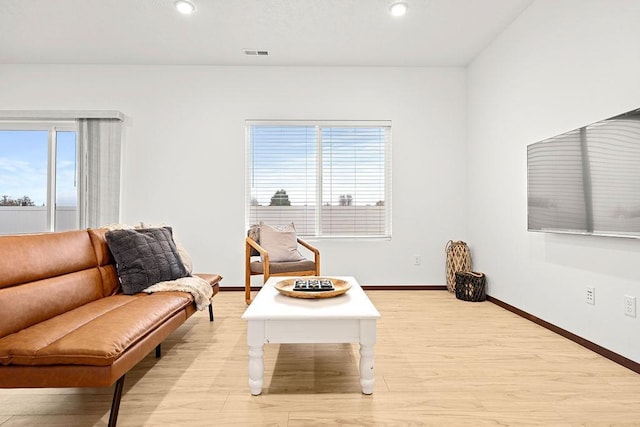 living area with recessed lighting, baseboards, light wood finished floors, and visible vents