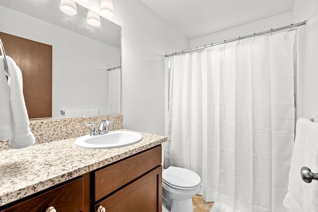 bathroom with vanity, tile patterned flooring, and toilet