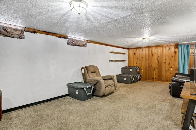 living area with baseboards, carpet, and a textured ceiling