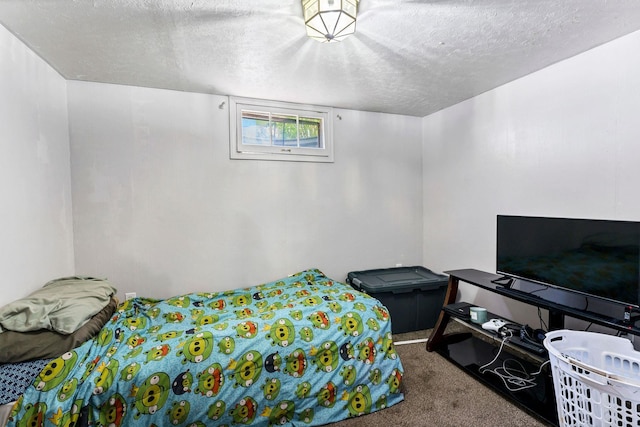 bedroom with carpet and a textured ceiling